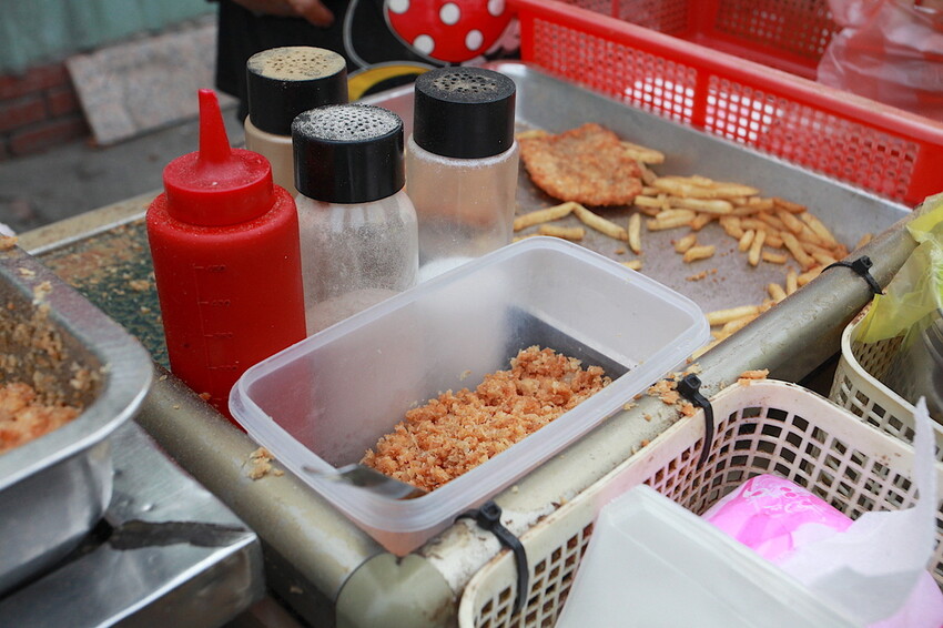 台南市南區吃。台南市｜南區。「灣裡薯條脆肉店」飄香30幾年超人氣排隊路邊攤位，超高CP值炸豬排每片15元、脆肉每份35