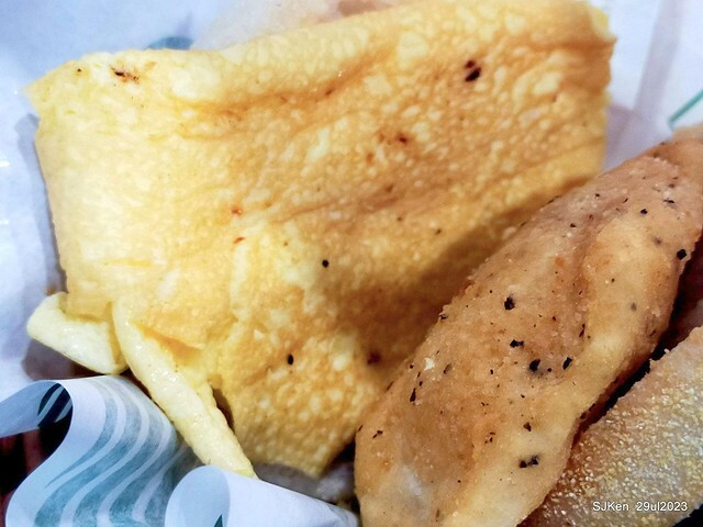 Muffin burger with fish steak and fried egg and Ceylon black tea at Taiwan fastfood store 