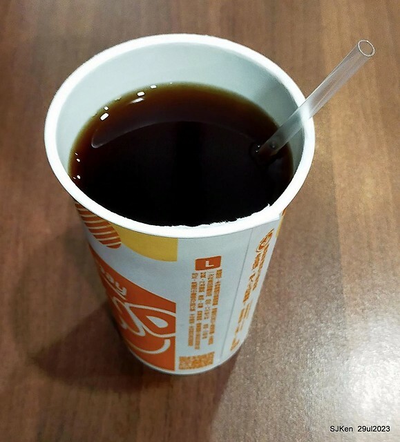 Muffin burger with fish steak and fried egg and Ceylon black tea at Taiwan fastfood store 